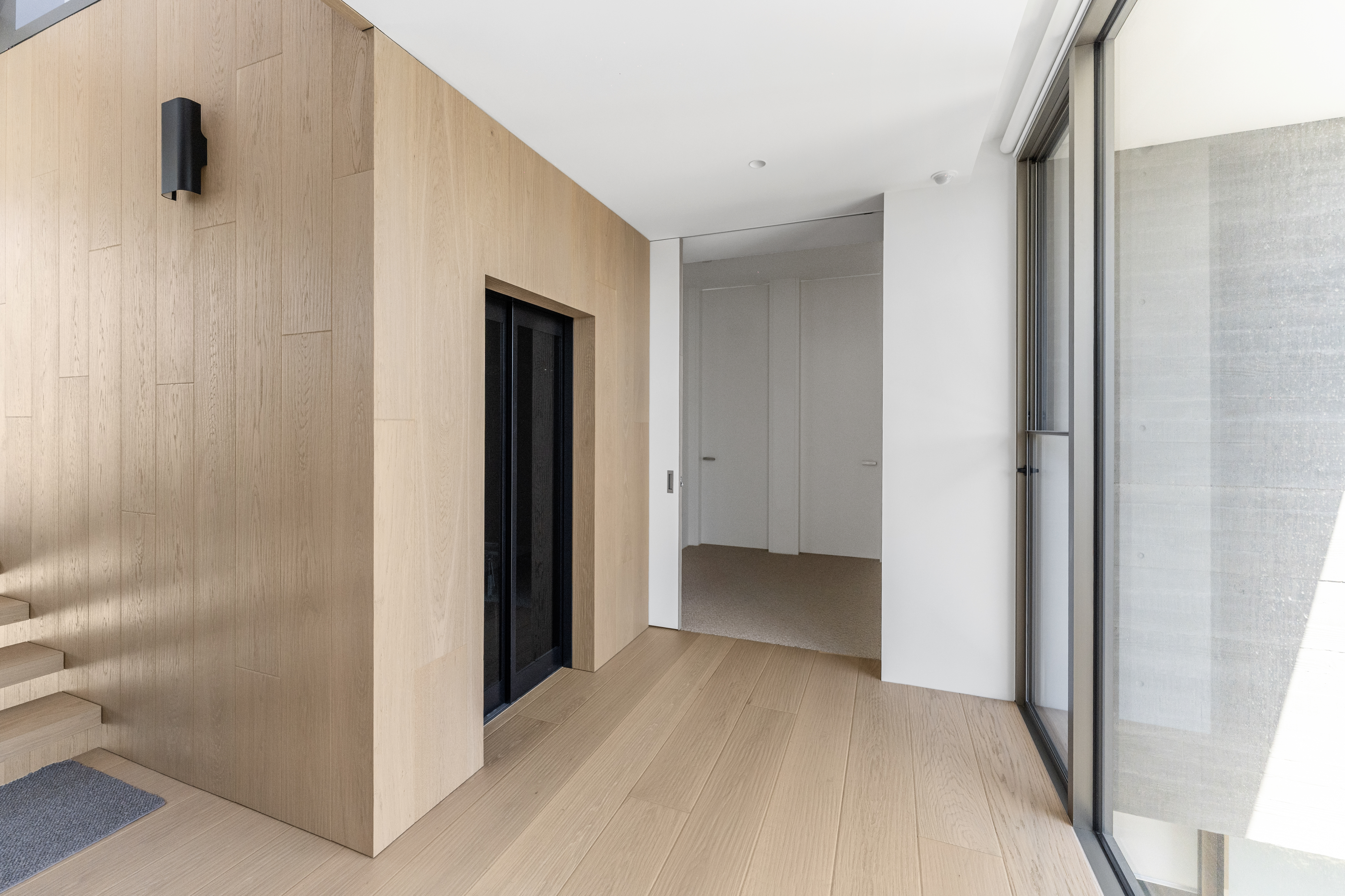 Black Rock — entry with timber-clad walls